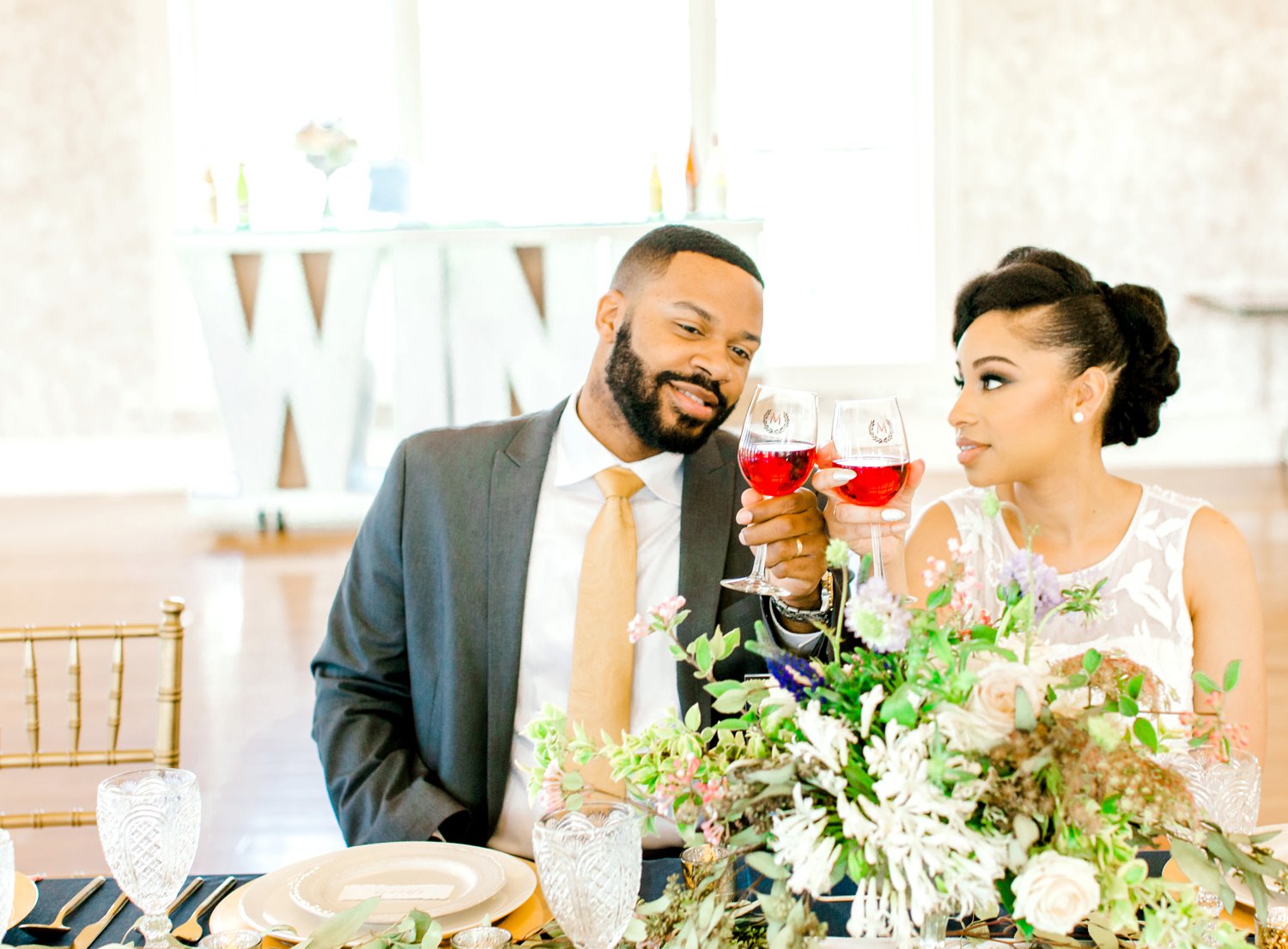 Bride and groom toasting wine glasses at reception