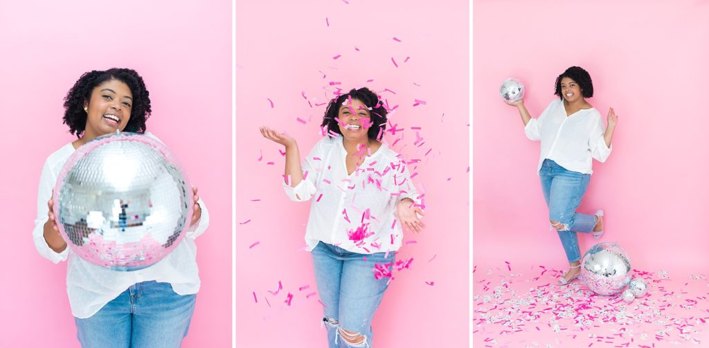 Woman celebrating with a disco ball and confetti in front of pink backdrop.
