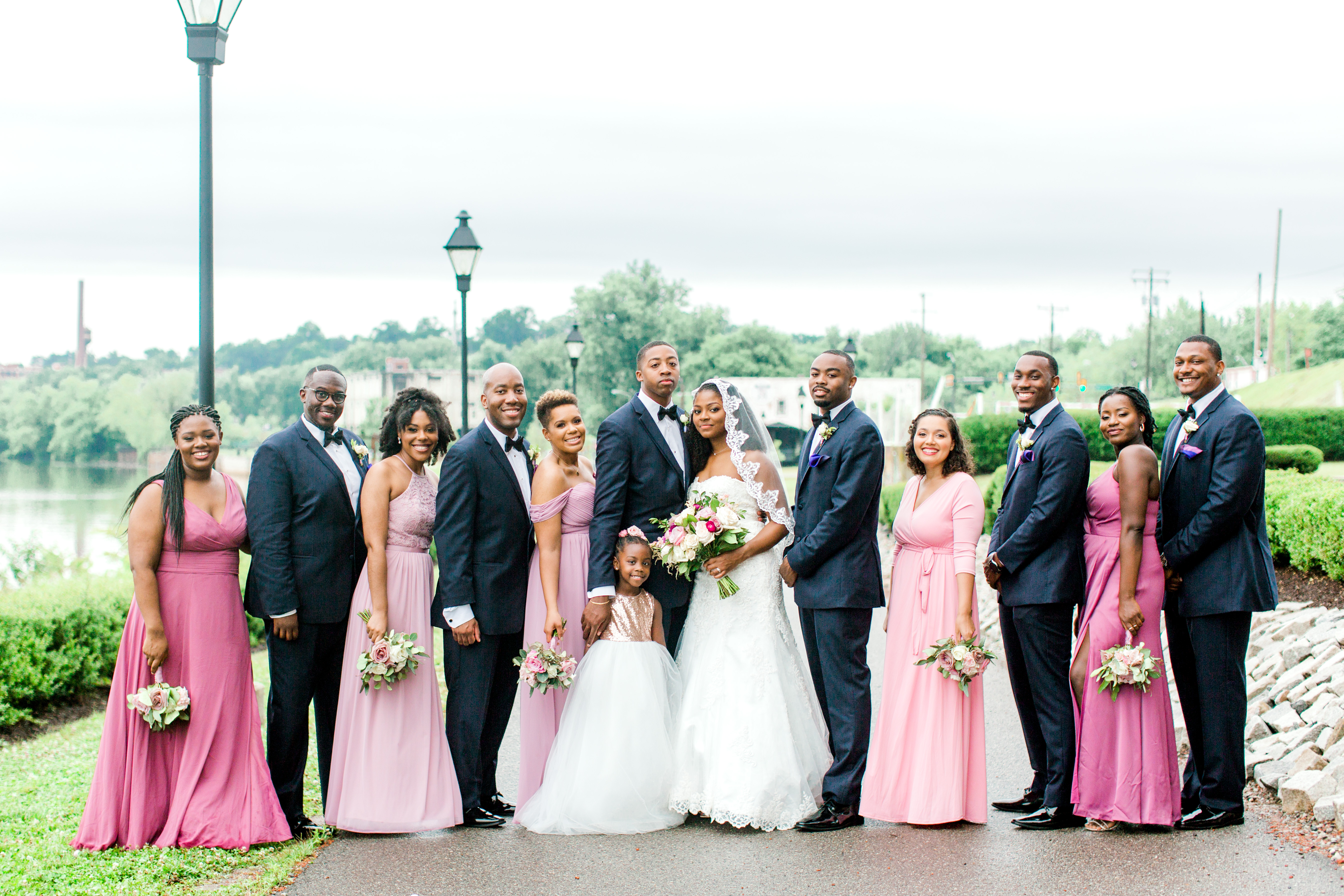 Wedding bridal party standing outside wearing navy and blush